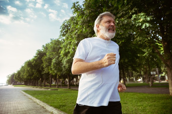 A gray-haired man jogging - physical fitness helps overcome depression