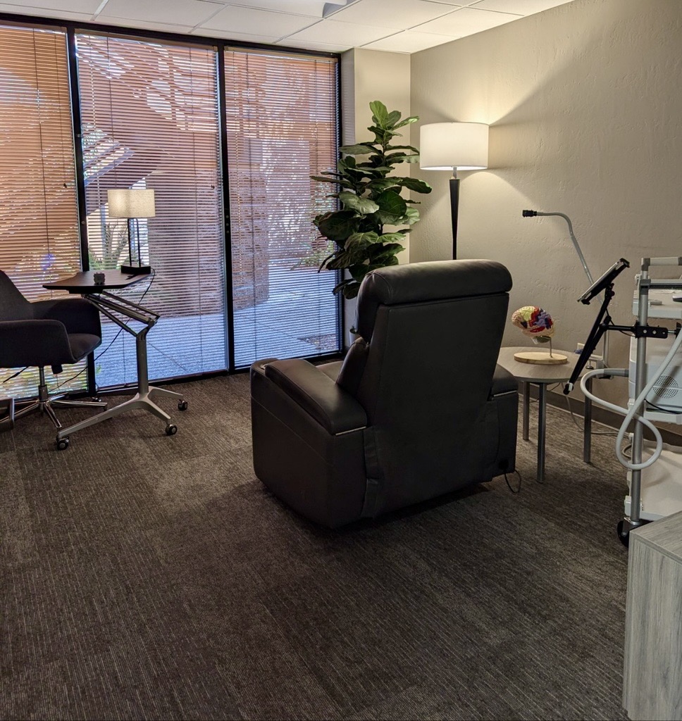 Transcranial Magnetic Stimulation (TMS) 1 MHCA TMS treatment room — a comfortable recliner beside a window with the TMS system nearby